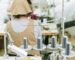 Sewing machines and workers in a textile factory, highlighting industrial manufacturing processes.
